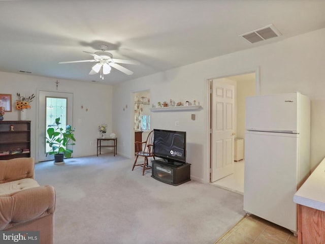  - living room featuring ceiling fan and light colored carpet