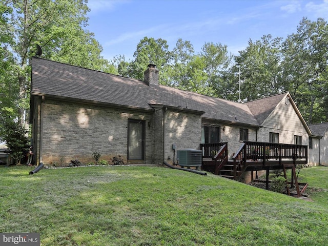  - back of property featuring a deck, brick siding, a yard, and a chimney