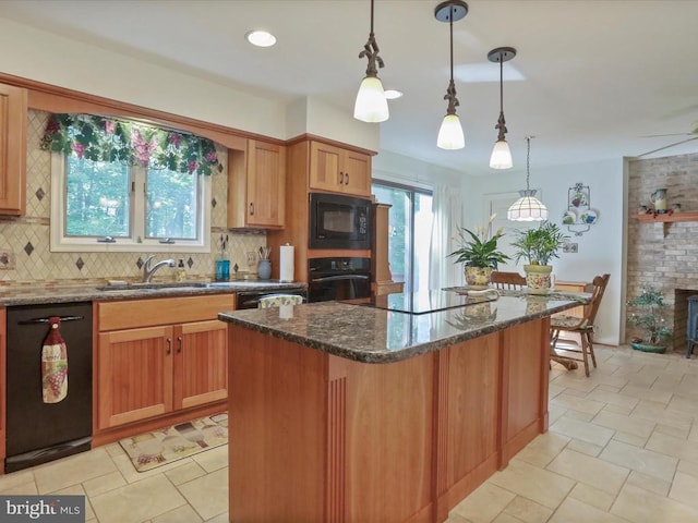 - kitchen featuring black appliances, tasteful backsplash, dark stone countertops, a center island, and hanging light fixtures
