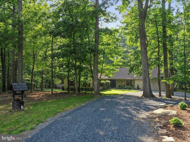  - view of front facade with gravel driveway