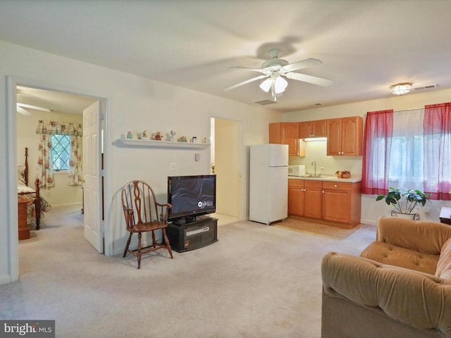  - living area with ceiling fan and light colored carpet