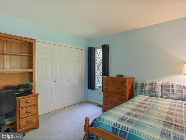  - carpeted bedroom featuring a closet and an office area