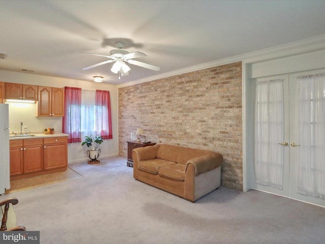 - living room featuring light carpet, french doors, ceiling fan, brick wall, and crown molding