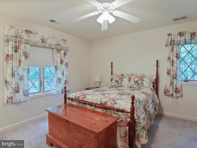  - carpeted bedroom with multiple windows and ceiling fan