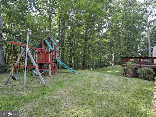 - view of green lawn with a playground and a wooden deck