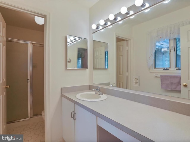  - full bathroom with a stall shower, vanity, and tile patterned flooring