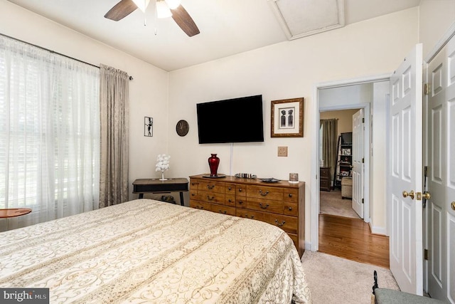 bedroom featuring carpet flooring, attic access, and ceiling fan