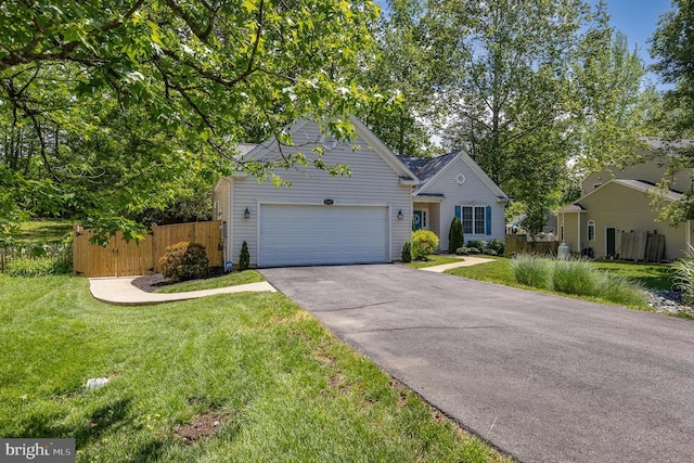 view of front of property with an attached garage and asphalt driveway