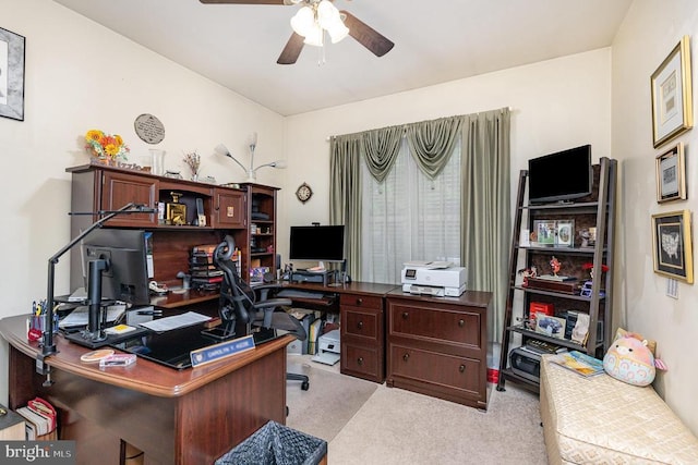 carpeted office featuring a ceiling fan