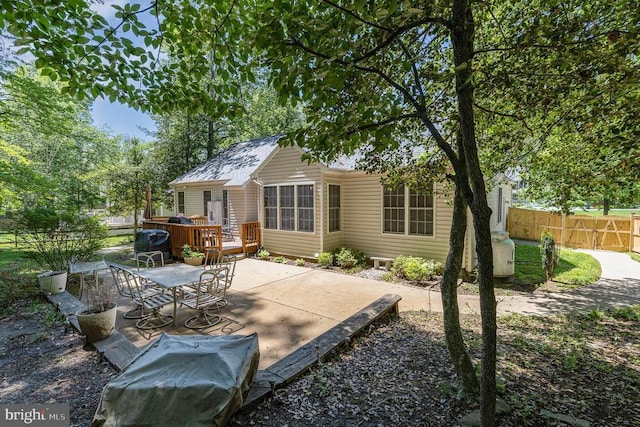 back of property featuring a patio area, fence, and outdoor dining space