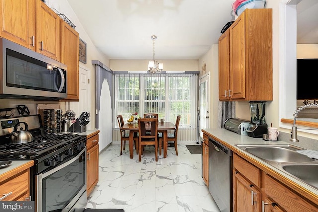 kitchen featuring appliances with stainless steel finishes, light marble finish flooring, a chandelier, a sink, and light countertops