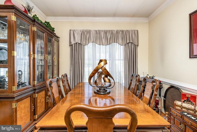 dining space featuring crown molding