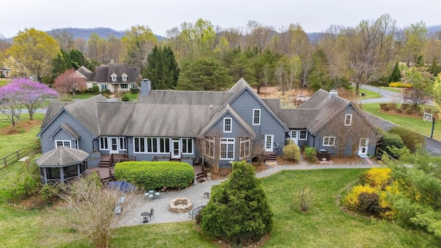 27 Black Walnut Ln, Nellysford, VA 22958 - rear view of property featuring an outdoor fire pit, a yard, roof with shingles, and a wooded view