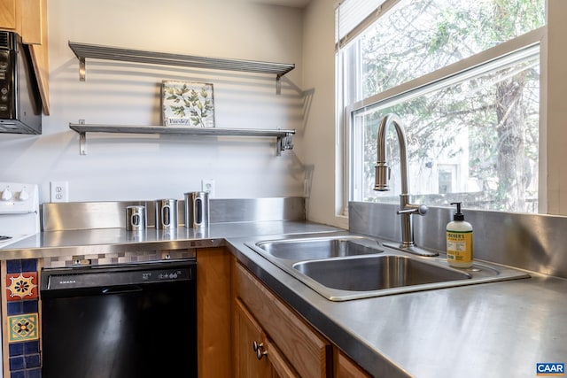 kitchen with black appliances, brown cabinets, stainless steel countertops, and a sink