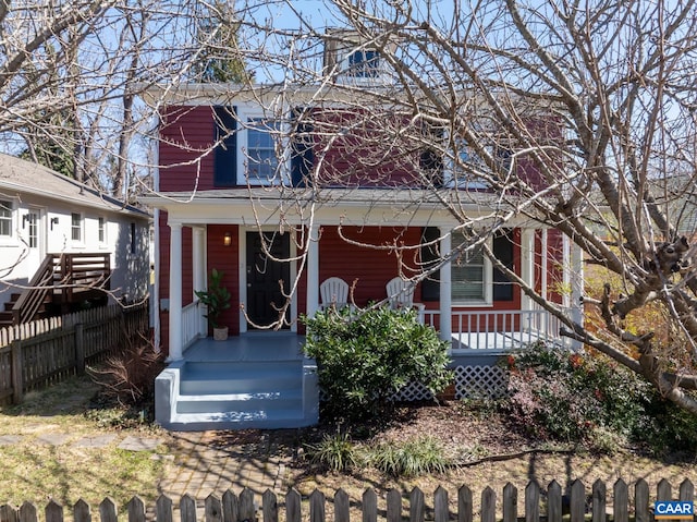 view of front of property featuring covered porch and a fenced front yard