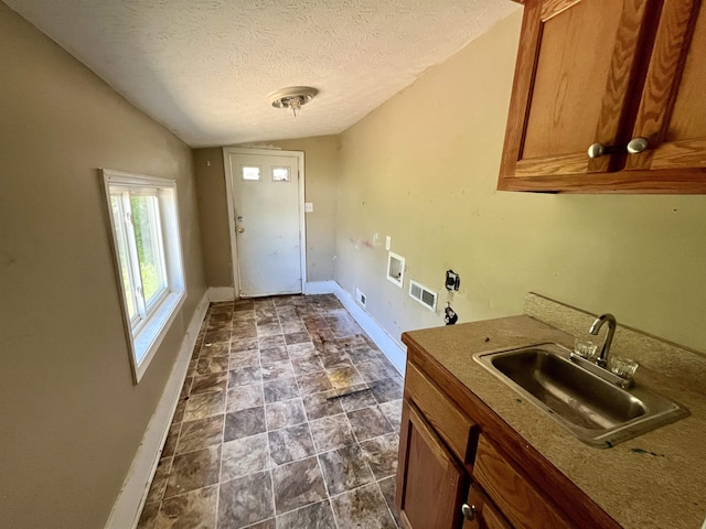 1112 Butler St, Staunton, VA 24401 - washroom featuring electric dryer hookup, hookup for a washing machine, baseboards, cabinet space, and a textured ceiling