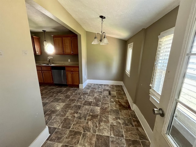 1112 Butler St, Staunton, VA 24401 - kitchen featuring stainless steel dishwasher, brown cabinets, baseboards, a textured ceiling, and a sink