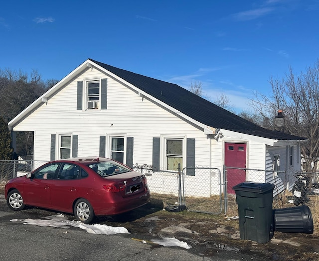 view of front of home with a chimney and fence