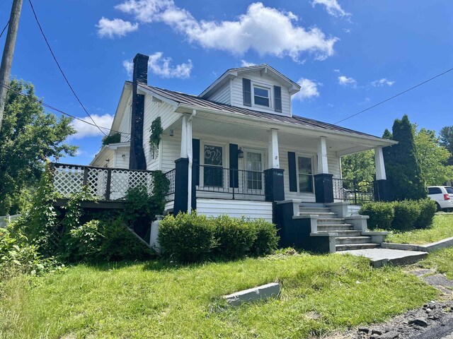 1112 Butler St, Staunton, VA 24401 - bungalow-style home with a standing seam roof, a chimney, a porch, and metal roof