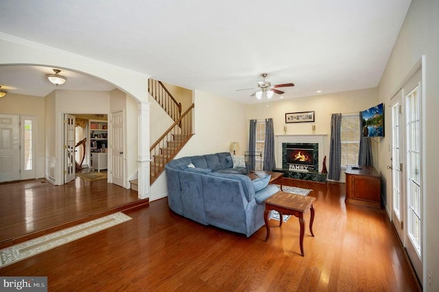9920 Post Oak Rd, Spotsylvania, VA 22551 - living area featuring a ceiling fan, arched walkways, stairway, and wood finished floors