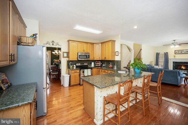 9920 Post Oak Rd, Spotsylvania, VA 22551 - kitchen featuring stainless steel appliances, light wood-type flooring, a peninsula, open floor plan, and recessed lighting
