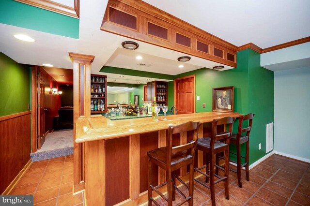 9920 Post Oak Rd, Spotsylvania, VA 22551 - indoor wet bar with ornate columns, tile patterned flooring, crown molding, baseboards, and recessed lighting