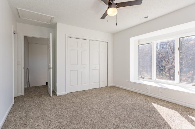 unfurnished bedroom featuring light carpet, ceiling fan, and a closet