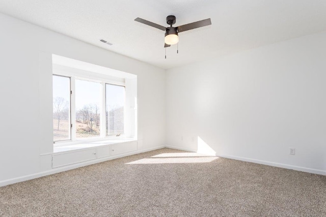 spare room with carpet floors and ceiling fan