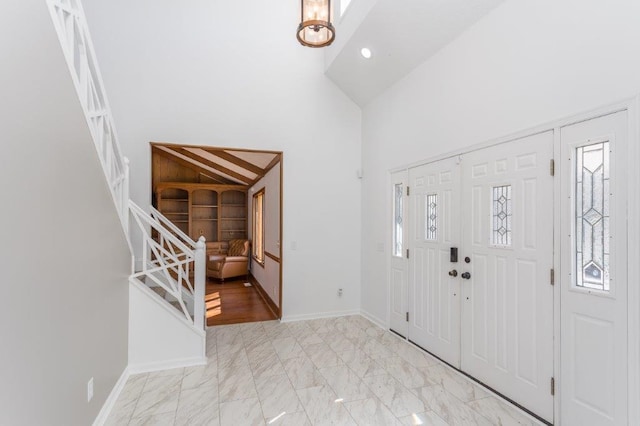 foyer entrance with high vaulted ceiling