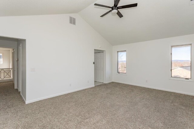 carpeted spare room with high vaulted ceiling and ceiling fan