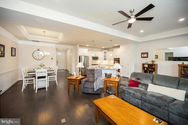 9822 White Oak Swamp Ct, Fredericksburg, VA 22407 - living area featuring a tray ceiling, a ceiling fan, dark wood-style floors, a chandelier, and baseboards