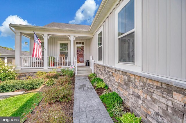 9822 White Oak Swamp Ct, Fredericksburg, VA 22407 - view of exterior entry featuring covered porch, board and batten siding, and stone siding