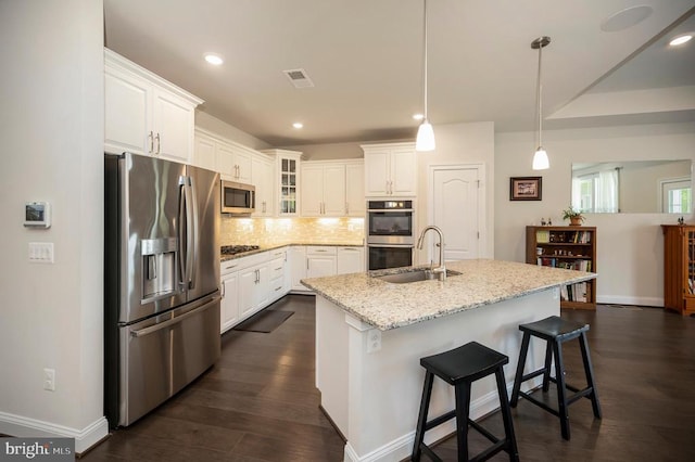 9822 White Oak Swamp Ct, Fredericksburg, VA 22407 - kitchen with appliances with stainless steel finishes, a sink, backsplash, baseboards, and white cabinetry