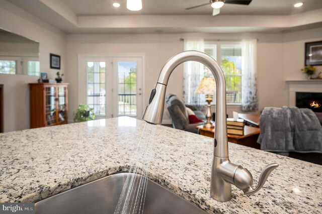 9822 White Oak Swamp Ct, Fredericksburg, VA 22407 - kitchen view of a sink, light stone counters, a ceiling fan, recessed lighting, and a raised ceiling