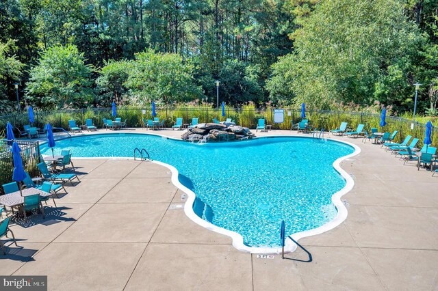 9822 White Oak Swamp Ct, Fredericksburg, VA 22407 - community pool featuring fence, a patio, and view of wooded area