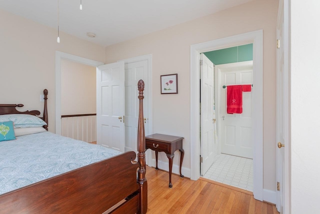 222 Grattan St E, Harrisonburg, VA 22801 - bedroom with light wood-style floors, baseboards, and ensuite bath