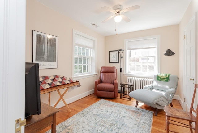 222 Grattan St E, Harrisonburg, VA 22801 - sitting room with radiator heating unit, wood finished floors, ceiling fan, and baseboards