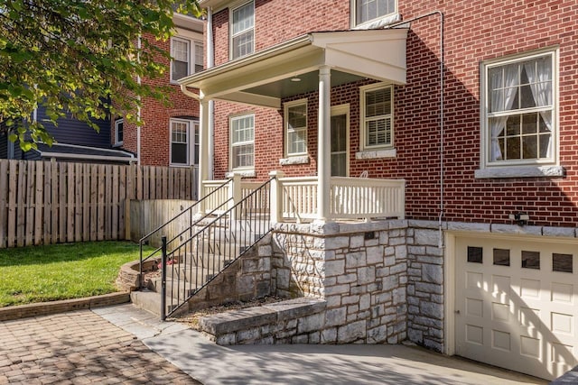 222 Grattan St E, Harrisonburg, VA 22801 - doorway to property with brick siding, an attached garage, and stone siding