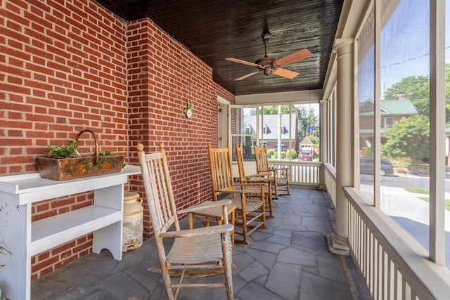 222 Grattan St E, Harrisonburg, VA 22801 - sunroom / solarium featuring brick wall, ceiling fan, and stone tile flooring