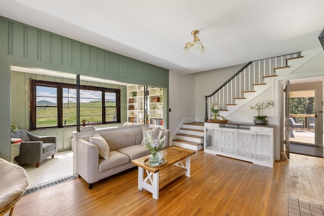 93 Eidson Creek Rd, Staunton, VA 24401 - living area featuring stairs, wood-type flooring, and a chandelier