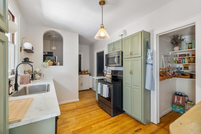 93 Eidson Creek Rd, Staunton, VA 24401 - kitchen with appliances with stainless steel finishes, green cabinetry, a sink, light countertops, and light wood-type flooring
