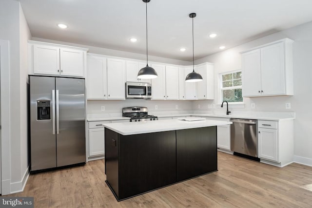 Old Lawyers Rd, Unionville, VA 22567 - kitchen featuring appliances with stainless steel finishes, light countertops, light wood finished floors, a center island, and white cabinets