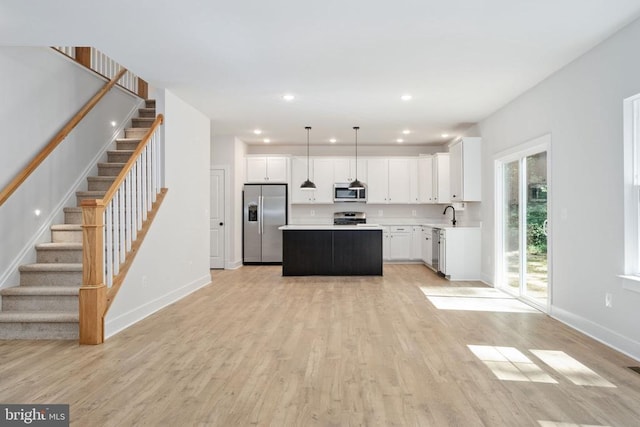 Old Lawyers Rd, Unionville, VA 22567 - kitchen with appliances with stainless steel finishes, baseboards, a kitchen island, light countertops, and light wood-style flooring