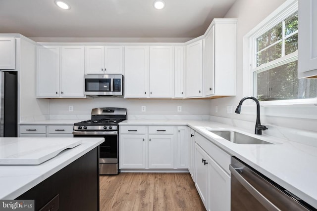 Old Lawyers Rd, Unionville, VA 22567 - kitchen featuring appliances with stainless steel finishes, a sink, white cabinetry, recessed lighting, and light stone countertops
