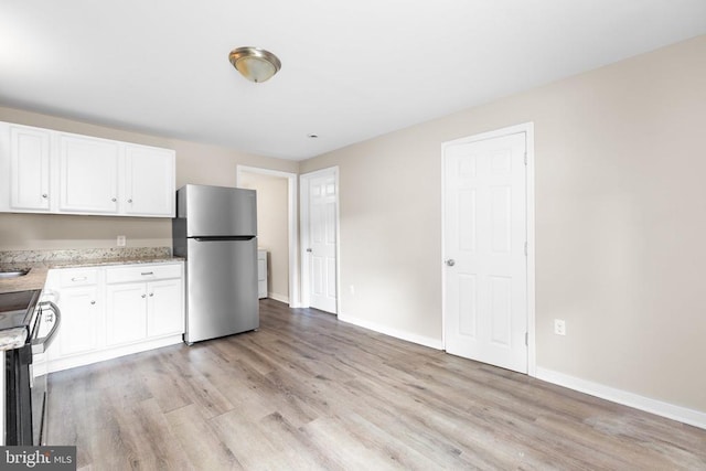 308 Virginia Ave, Mineral, VA 23117 - kitchen with appliances with stainless steel finishes, light wood-type flooring, white cabinets, and light stone countertops
