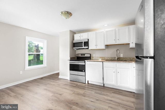 308 Virginia Ave, Mineral, VA 23117 - kitchen with stainless steel appliances, white cabinets, light wood-style floors, light stone countertops, and recessed lighting