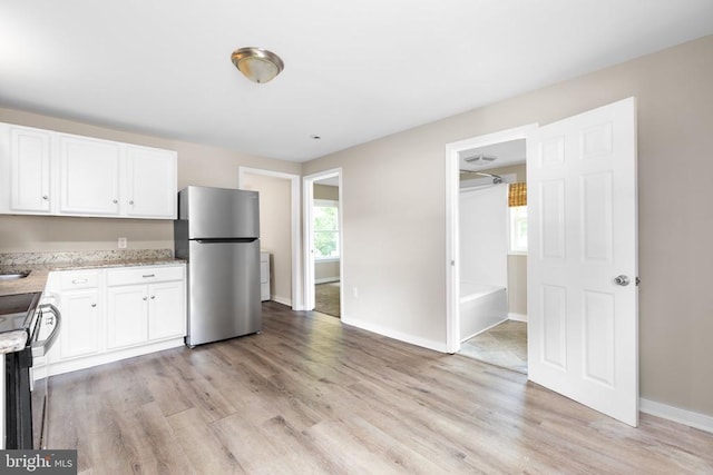 308 Virginia Ave, Mineral, VA 23117 - kitchen featuring appliances with stainless steel finishes, light wood-type flooring, and white cabinets