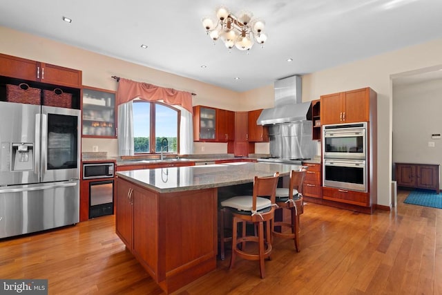 5442 Ellett Ln, Rixeyville, VA 22737 - kitchen with stainless steel appliances, wall chimney range hood, a center island, glass insert cabinets, and a chandelier