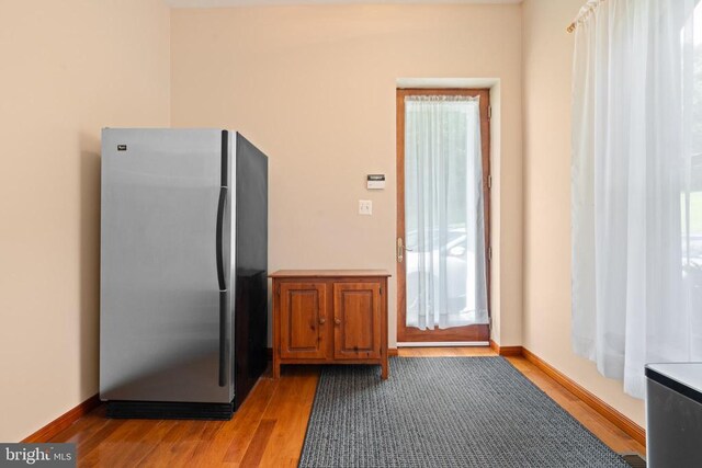 5442 Ellett Ln, Rixeyville, VA 22737 - kitchen with freestanding refrigerator, light wood-style flooring, and brown cabinets