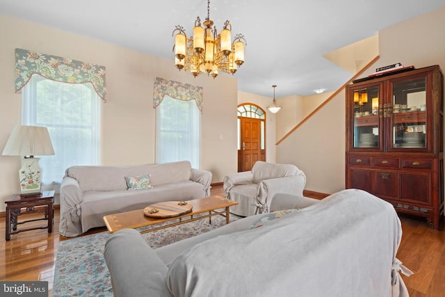 5442 Ellett Ln, Rixeyville, VA 22737 - living room featuring a chandelier, wood finished floors, stairway, and baseboards